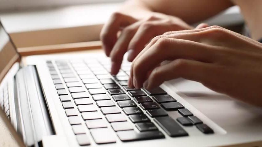 Closeup of hands typing on keyboard